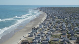 AX143_056 - 5.5K aerial stock footage flying over oceanfront homes, approaching coastal town, Marshfield, Massachusetts