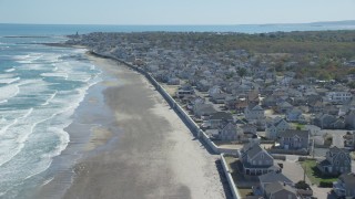 AX143_057 - 5.5K aerial stock footage flying over beach,  oceanfront homes, small coastal town, Marshfield, Massachusetts