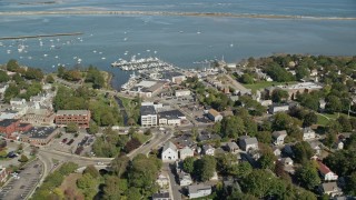 AX143_094E - 5.5K aerial stock footage flying by small coastal town, Plymouth Harbor, Plymouth, Massachusetts