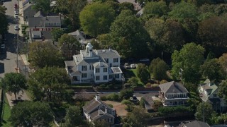 AX143_097 - 5.5K aerial stock footage flying by large home, small town, Plymouth, Massachusetts