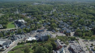 AX143_100 - 5.5K aerial stock footage flying over small town stores and homes, Plymouth, Massachusetts