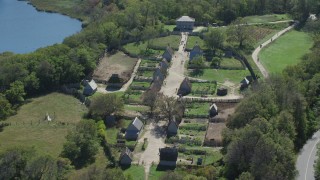 AX143_108 - 5.5K stock footage aerial video orbiting Plimoth Plantation, revealing body of water,  Plymouth, Massachusetts