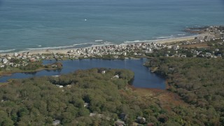 AX143_117E - 5.5K aerial stock footage flying by small coastal community, reveal Bartlett Pond, Plymouth, Massachusetts