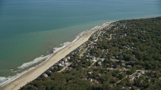 AX143_121E - 5.5K aerial stock footage flying over small town, beachfront homes, Cape Cod Bay, Plymouth, Massachusetts