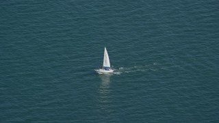 AX143_125 - 5.5K aerial stock footage tracking a sailing boat on Cape Cod Bay, Massachusetts