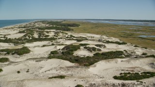 AX143_134E - 5.5K aerial stock footage flying over sand dunes, beach and isolated home, Barnstable, Cape Cod, Massachusetts