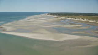 AX143_147E - 5.5K aerial stock footage flying over sand bars, approach small coastal town, Cape Cod, Dennis, Massachusetts