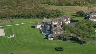 AX143_160E - 5.5K aerial stock footage orbiting mansion, Cape Cod, Dennis, Massachusetts