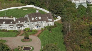 AX143_169 - 5.5K aerial stock footage orbiting front of mansion, Cape Cod, Dennis, Massachusetts