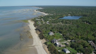 AX143_172 - 5.5K aerial stock footage flying over beach, beachfront homes, Cape Cod, Brewster, Massachusetts
