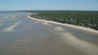 AX143_174 - 5.5K aerial stock footage flying by beach, beachfront homes, sand bars, Cape Cod, Brewster, Massachusetts