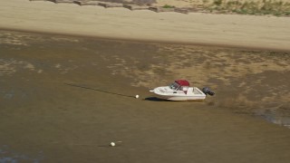 AX143_187 - 5.5K aerial stock footage flying by beached fishing boat on sandbar, Cape Cod, Eastham, Massachusetts