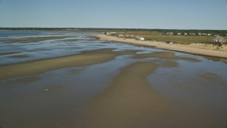 AX143_188 - 5.5K aerial stock footage flying over sand bar, by beachfront homes, Cape Cod, Eastham, Massachusetts