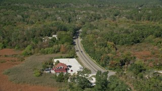AX143_199E - 5.5K aerial stock footage panning right by Highway 6 through forest, Wellfleet, Massachusetts