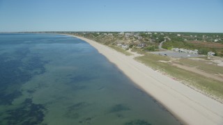 AX143_206 - 5.5K aerial stock footage flying over beach, approaching homes, Cape Cod, Truro, Massachusetts