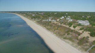 AX143_208 - 5.5K aerial stock footage flying by beach, homes with ocean views, Cape Cod, Truro, Massachusetts