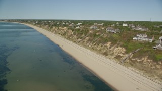 AX143_208E - 5.5K aerial stock footage flying by beach, homes with ocean views, Cape Cod, Truro, Massachusetts