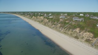 AX143_209 - 5.5K aerial stock footage flying by beach, homes with ocean views, Cape Cod, Truro, Massachusetts