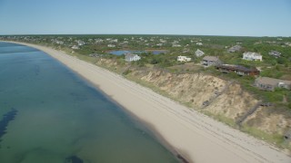 AX143_210 - 5.5K aerial stock footage flying by beach, homes with ocean views, Cape Cod, Truro, Massachusetts