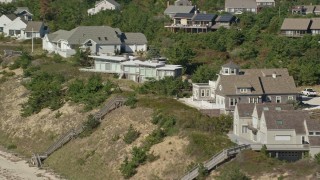 AX143_212 - 5.5K aerial stock footage flying by homes with ocean views, Cape Cod, Truro, Massachusetts