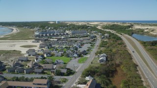 AX143_218 - 5.5K aerial stock footage of Highway 6, coastal road, Kalmar Village, Sandcastle Resort and Club, Truro, Massachusetts