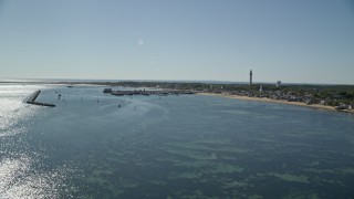AX143_221 - 5.5K aerial stock footage approaching piers, small coastal town, Provincetown, Massachusetts