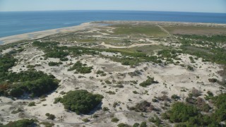 AX143_253 - 5.5K aerial stock footage flying by sand dunes, marshland, Cape Cod, Provincetown, Massachusetts