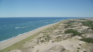 AX144_003 - 5.5K aerial stock footage flying over sand dunes, beach, beachfront homes, Provincetown, Massachusetts