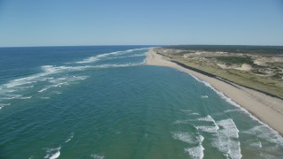 AX144_010 - 5.5K aerial stock footage flying over waves rolling onto beach, Cape Cod, Truro, Massachusetts