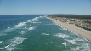 AX144_012 - 5.5K aerial stock footage flying over waves rolling onto beach, Cape Cod, Truro, Massachusetts