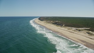 AX144_013 - 5.5K aerial stock footage flying by waves crashing, beach, Cape Cod, Truro, Massachusetts
