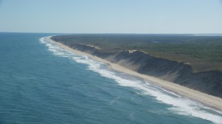 AX144_021 - 5.5K aerial stock footage flying by crashing waves, beaches, Cape Cod, Truro, Massachusetts