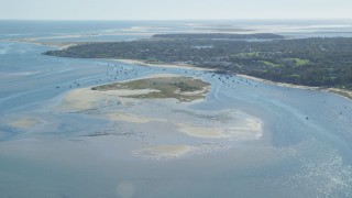 AX144_045 - 5.5K stock footage aerial video approaching Strong Island, small coastal town, Chatham, Massachusetts