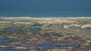 AX144_063 - 5.5K aerial stock footage flying by lighthouse on Monomoy Island, Cape Cod, Massachusetts