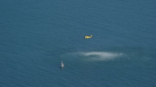 AX144_068 - 5.5K aerial stock footage flying by Coast Guard helicopter, rescue practice, Atlantic Ocean