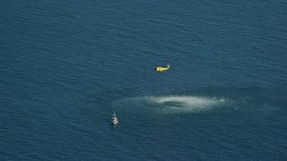 AX144_068E - 5.5K aerial stock footage flying by Coast Guard helicopter, rescue practice, Atlantic Ocean