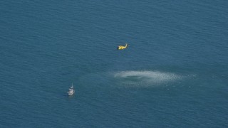 AX144_069 - 5.5K aerial stock footage flying by Coast Guard helicopter, rescue practice, Atlantic Ocean