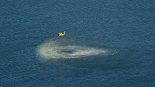 AX144_070 - 5.5K aerial stock footage flying by a Coast Guard helicopter conducting rescue practice, Atlantic Ocean