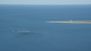 AX144_071 - 5.5K aerial stock footage of a Coast Guard helicopter, rescue practice, Great point Light, Nantucket, Massachusetts