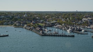AX144_079E - 5.5K aerial stock footage flying by coastal community, piers, Nantucket, Massachusetts