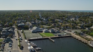 AX144_082E - 5.5K aerial stock footage approaching church in a small coastal town from over the water,  Nantucket, Massachusetts