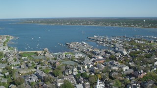 AX144_085 - 5.5K stock footage aerial video orbiting small coastal town, Nantucket Harbor, Nantucket, Massachusetts
