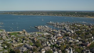 AX144_085E - 5.5K aerial stock footage orbiting small coastal town, Nantucket Harbor, Nantucket, Massachusetts