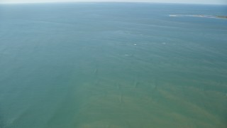 AX144_121 - 5.5K stock footage aerial video flying out over Atlantic Ocean from Tuckernuck Island, Nantucket, Massachusetts