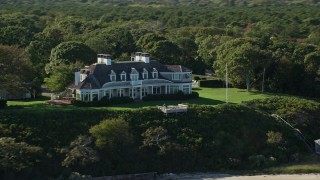 AX144_132 - 5.5K aerial stock footage flying by waterfront mansion, Edgartown, Martha's Vineyard, Massachusetts