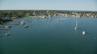 AX144_133E - 5.5K aerial stock footage flying over boats, small coastal town, Edgartown, Martha's Vineyard, Massachusetts