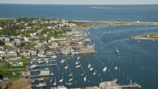 AX144_139 - 5.5K stock footage aerial video orbiting small coastal town, piers, Edgartown, Martha's Vineyard, Massachusetts