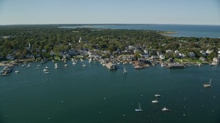 AX144_140 - 5.5K stock footage aerial video orbiting small coastal town, piers, Edgartown, Martha's Vineyard, Massachusetts