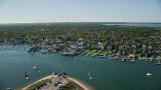 AX144_141 - 5.5K stock footage aerial video orbiting small coastal town, piers, Edgartown, Martha's Vineyard, Massachusetts