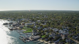 AX144_142 - 5.5K stock footage aerial video flying by small coastal town, Edgartown, Martha's Vineyard, Massachusetts